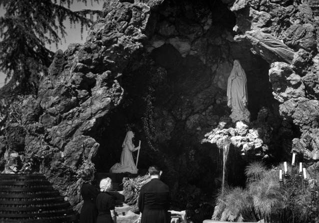 Statue of Virgin Mary in rocky Lourdes grotto for February 11 feast