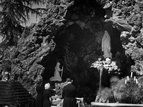 Statue of Virgin Mary in rocky Lourdes grotto for February 11 feast