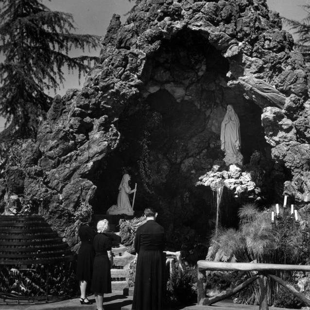 Statue of Virgin Mary in rocky Lourdes grotto for February 11 feast