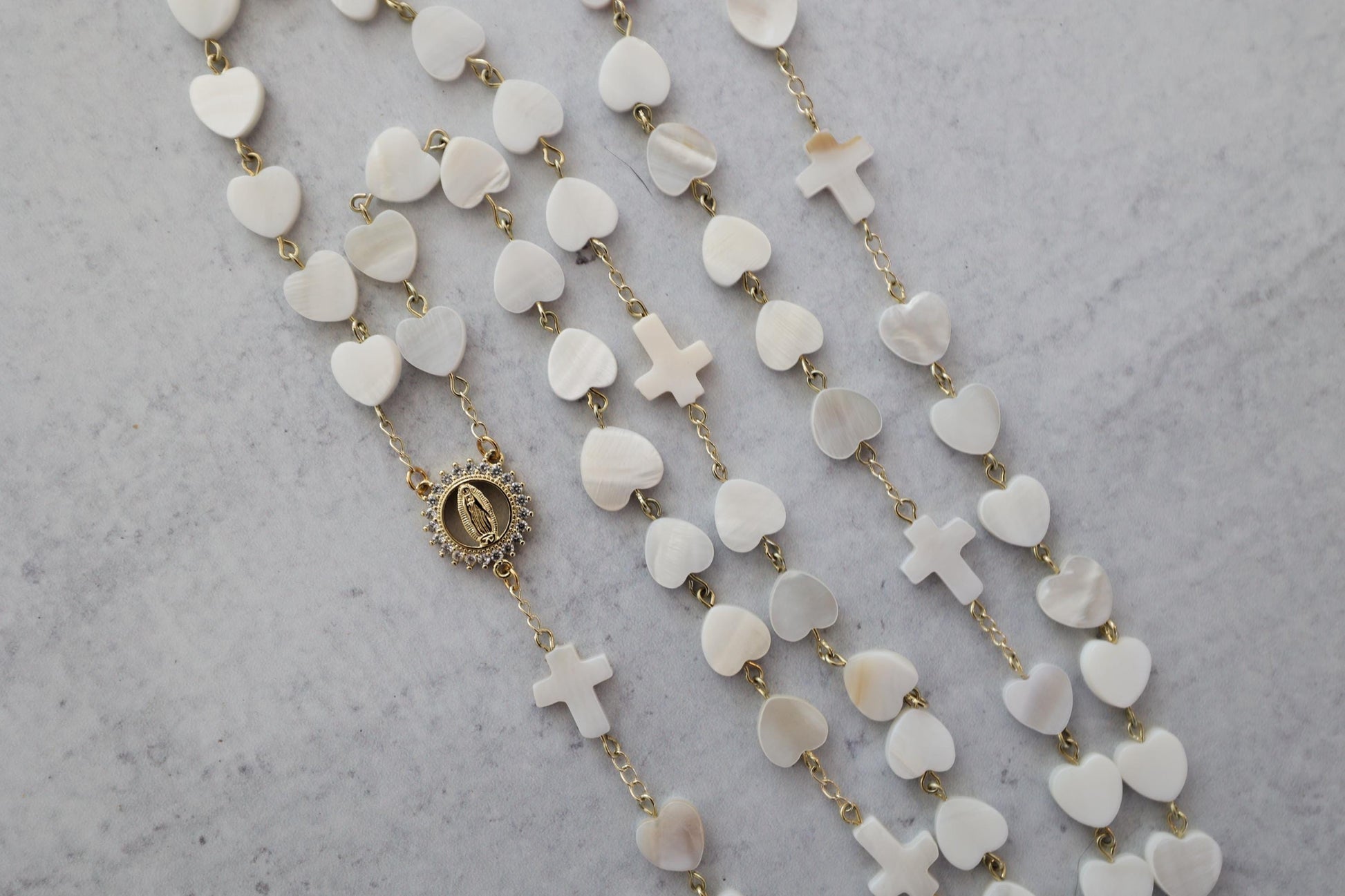 pearl heart shaped rosary with luminous heart beads and delicate cross accents, featuring Mother Mary centerpiece