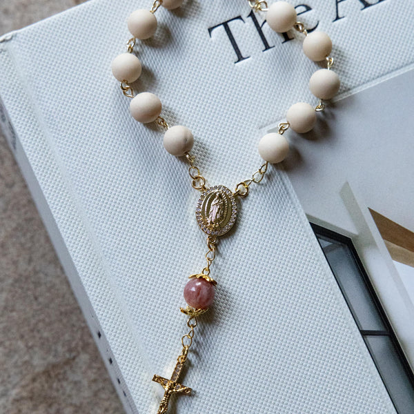 Soft Glory Car Decade Rosary: gold rosary bracelet with cream beads, pink gem, cross medallion