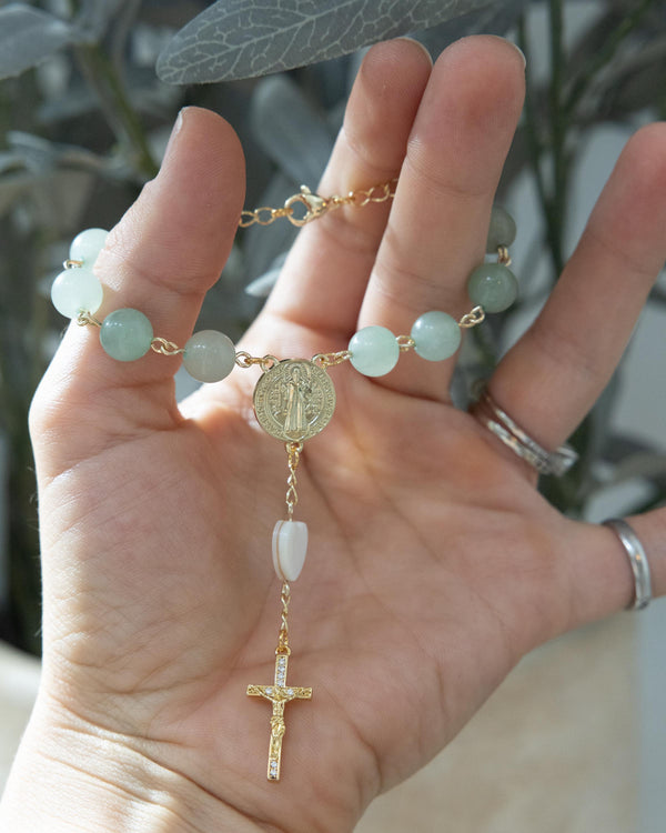Delicate gold rosary bracelet with jade beads, St. Benedict medal, and gemstone cross