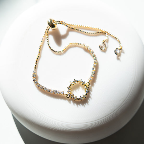 Gold-toned Crown of Thorns adjustable bracelet with crystal-encrusted circular design