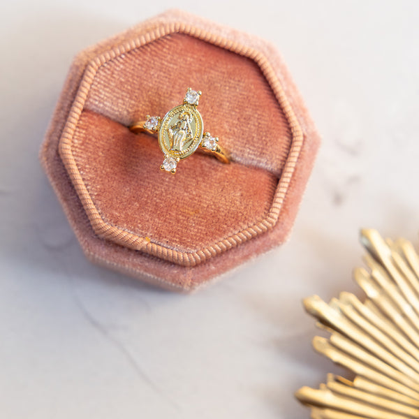 Gold Queen of Heaven ring with oval medallion and four clear stones