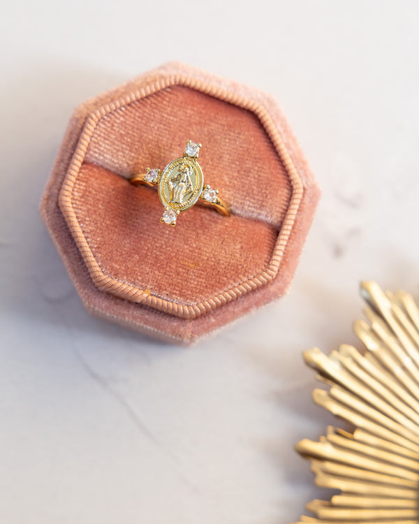 Gold Queen of Heaven ring with oval medallion and four clear stones