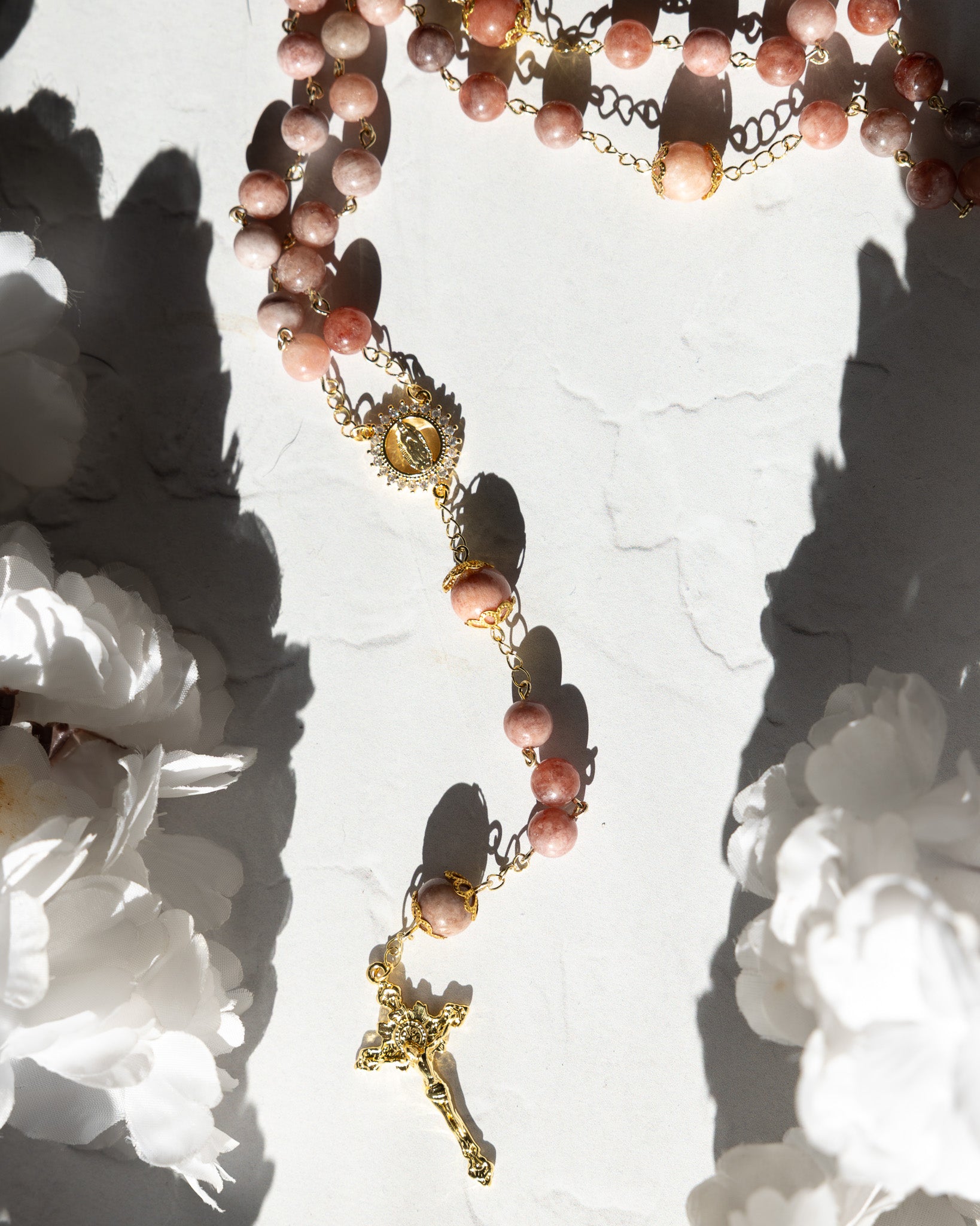 Mater Amoris rosary with pink translucent gemstone beads and gold crucifix