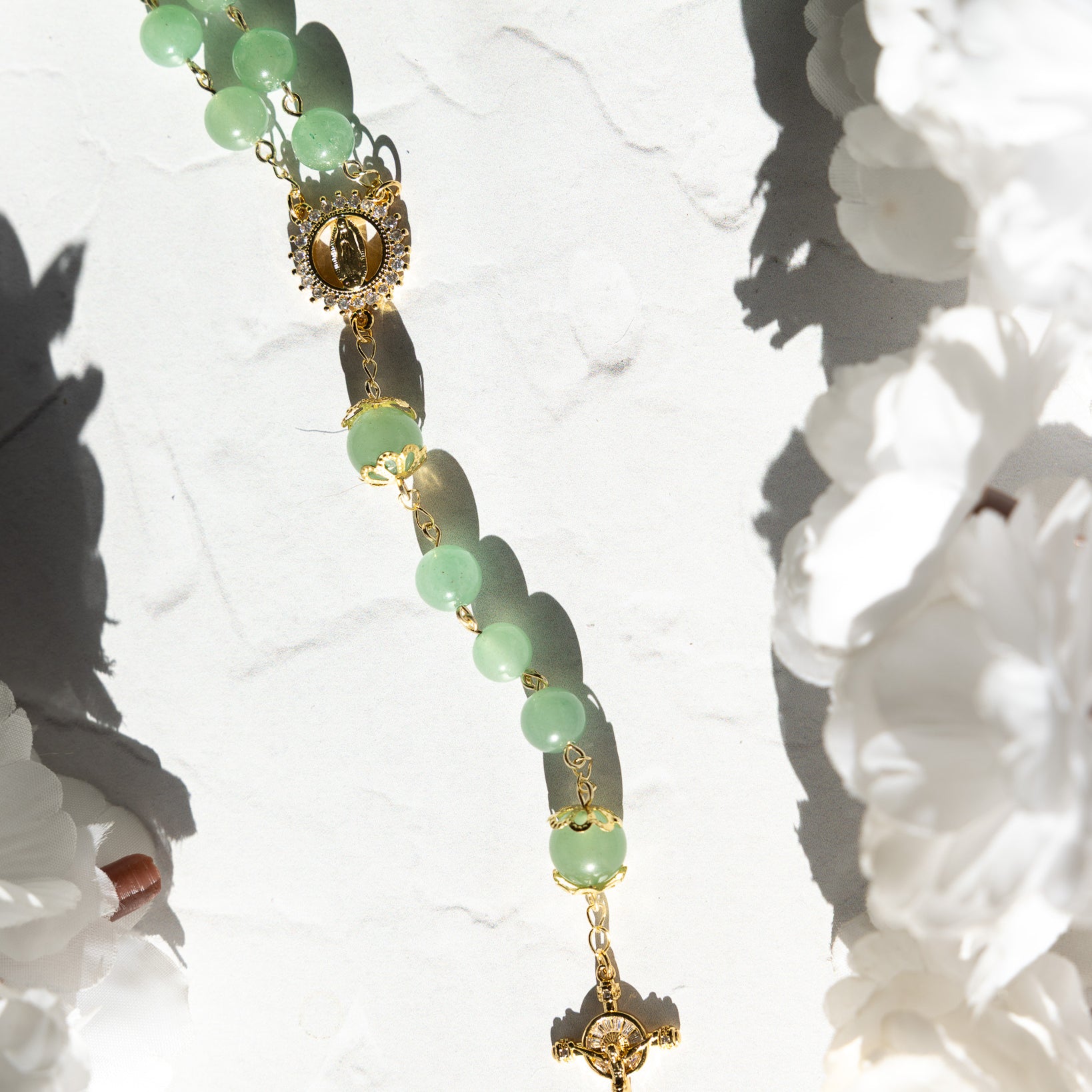 Jadeite rosary with delicate jade green beads, gold accents, and crucifix