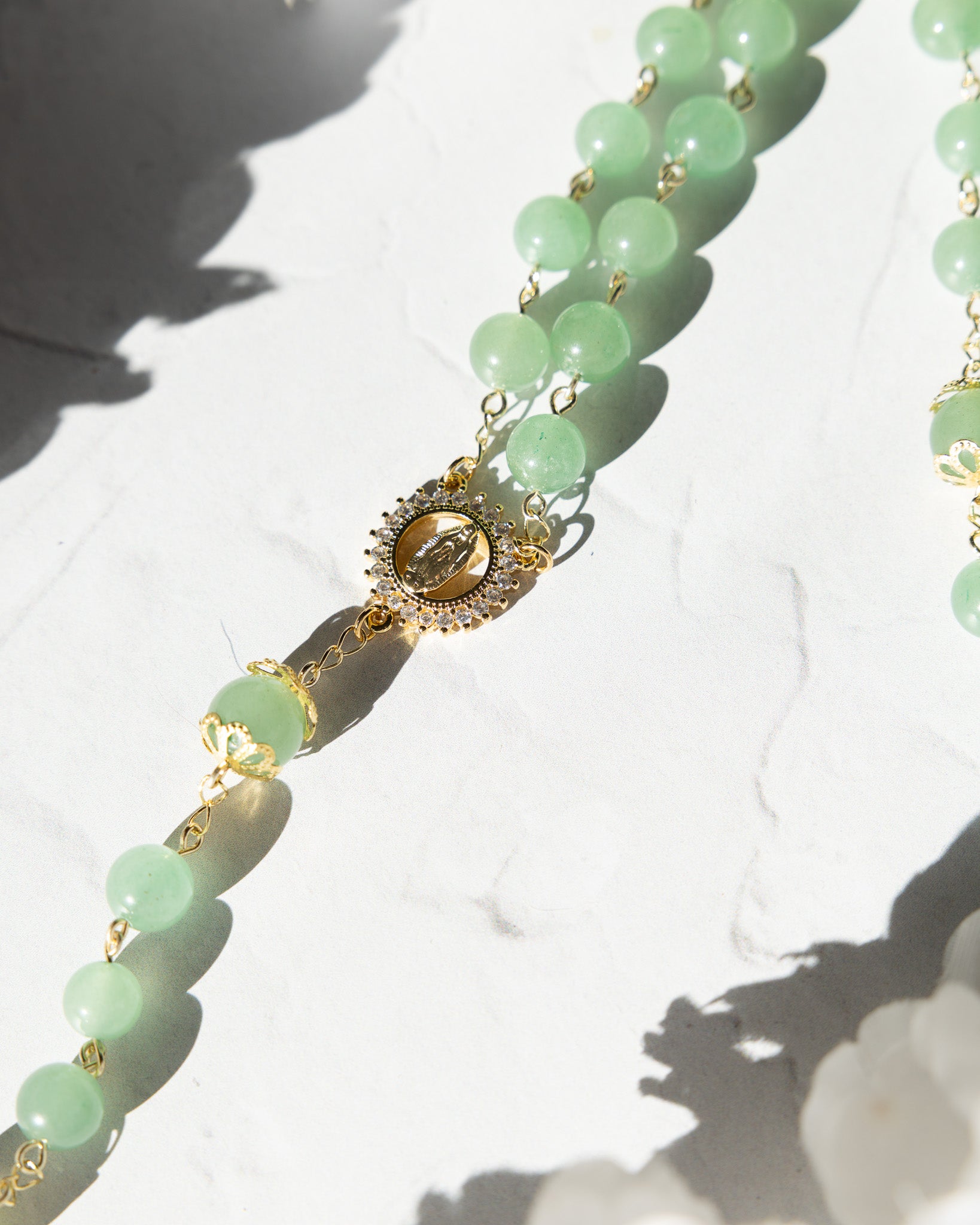 Jadeite rosary with jade-green beads, gold accents, and Virgin Mary medallion