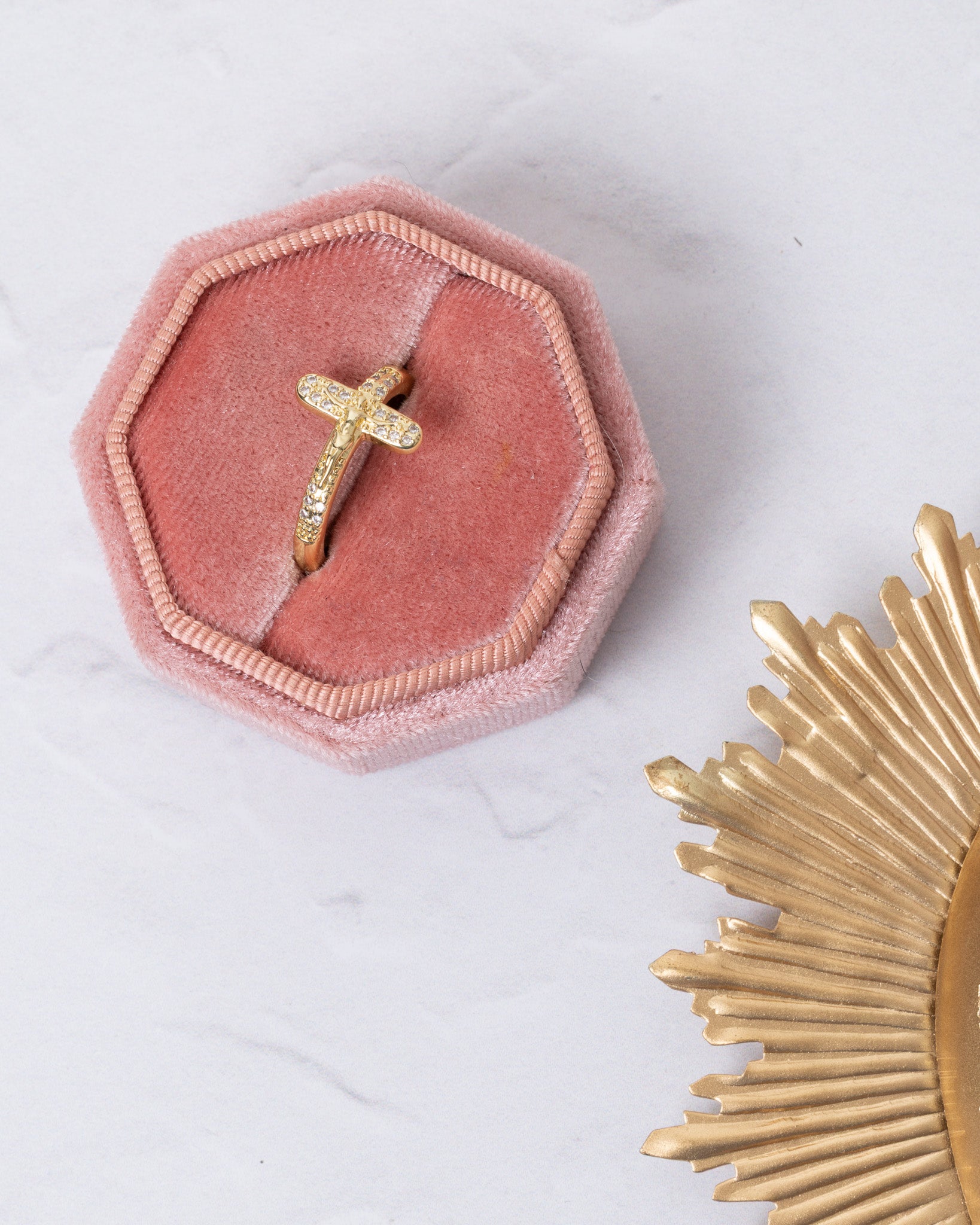 Delicate gold crucifix ring with sparkling stones in pink velvet box
