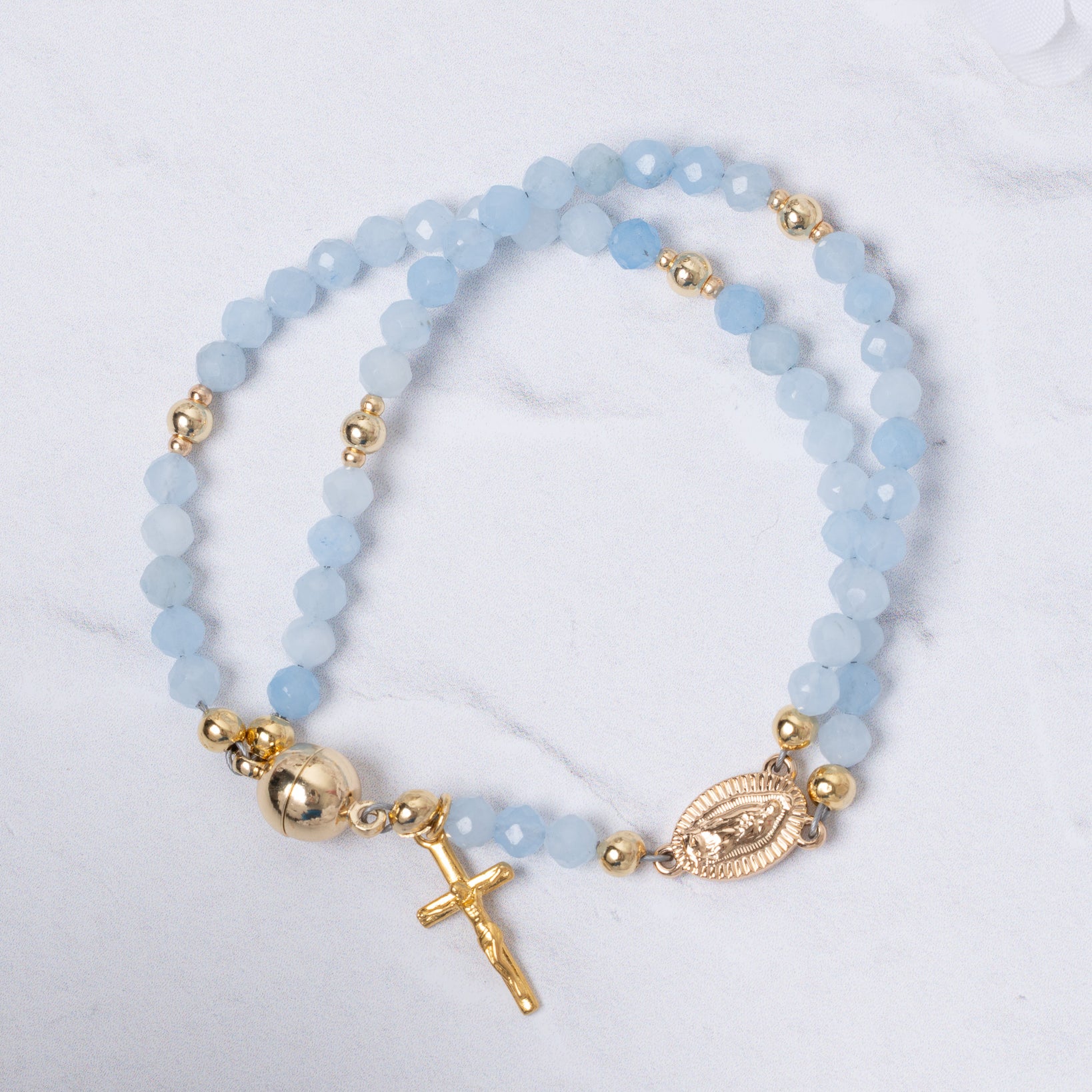 Stella Maris light blue beaded magnetic rosary bracelet with gold accents, cross charm, oval medallion