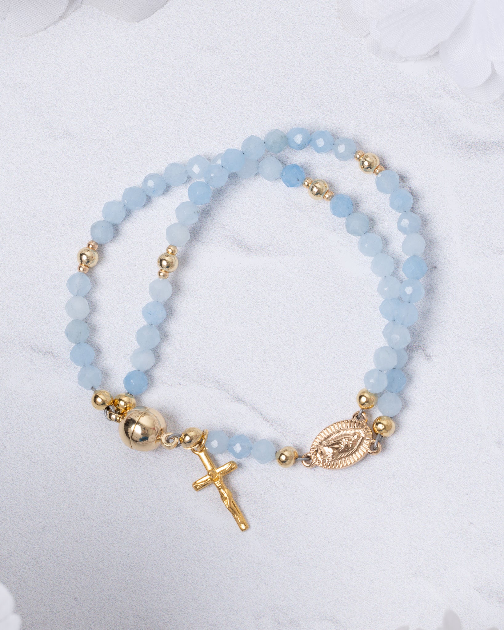 Stella Maris light blue beaded magnetic rosary bracelet with gold accents, cross charm, oval medallion