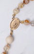 Gold-toned Guadalupe rosary medal with Virgin Mary engraving and amber quartz beads