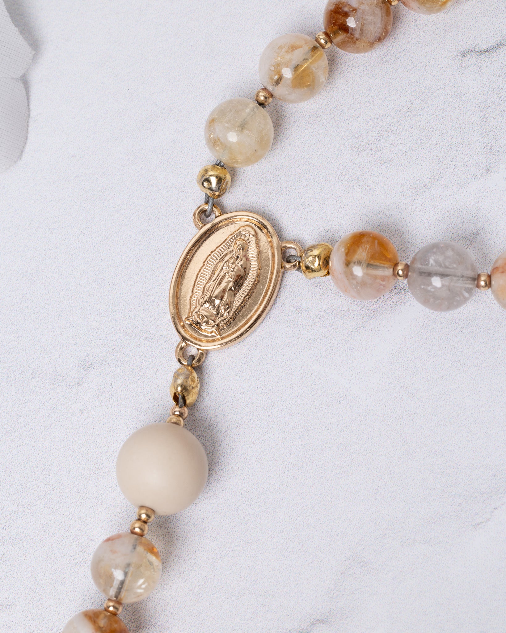 Gold-toned Guadalupe rosary medal with Virgin Mary engraving and amber quartz beads