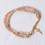 Sunstone magnetic rosary bracelet in delicate peach beads with gold accents