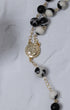 Black and white marbled bead rosary with gold chain and St. Benedict medal