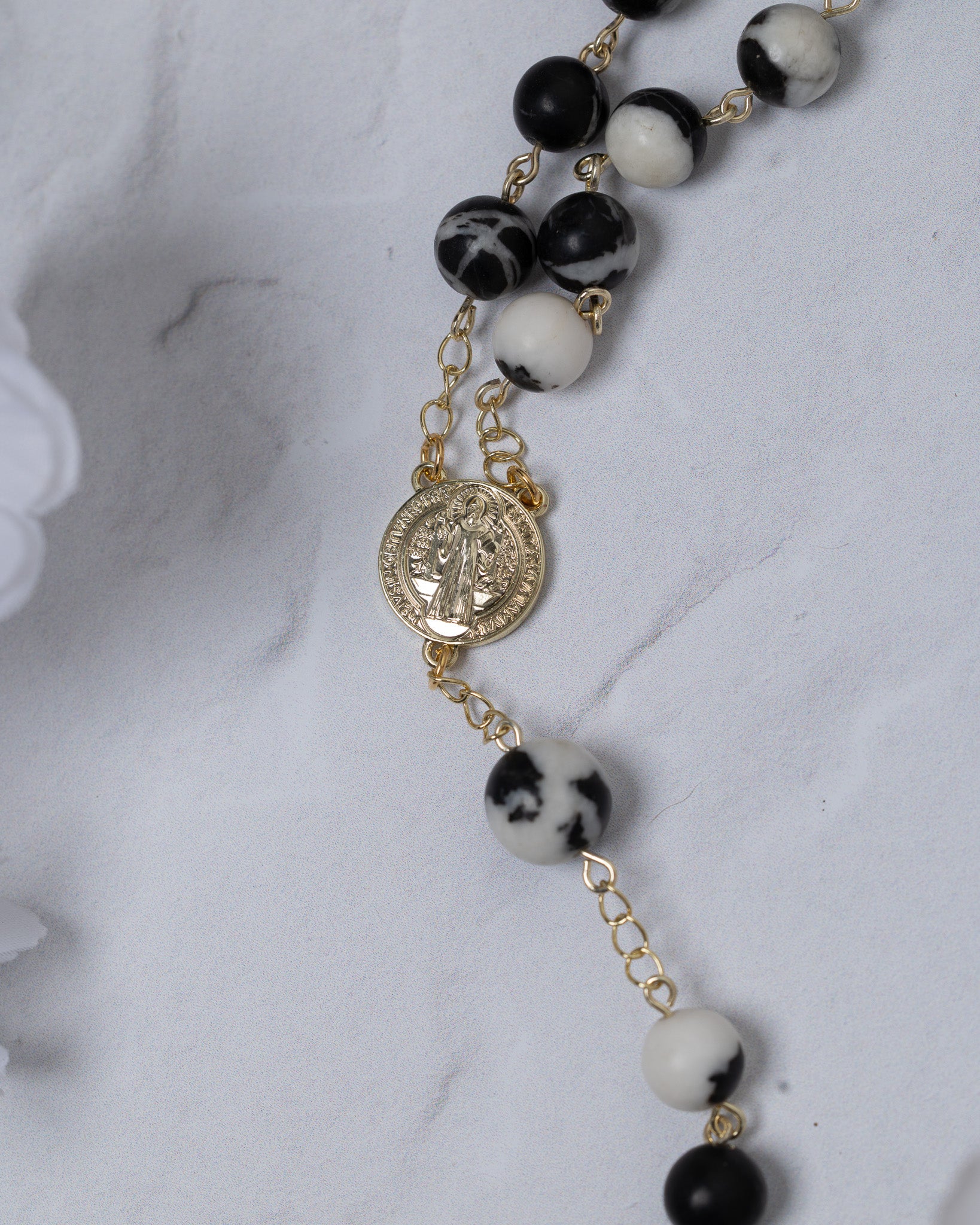 Black and white marbled bead rosary with gold chain and St. Benedict medal