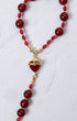 Red heart-shaped pendant necklace with gold accents and red beads, Seven Sorrows Chaplet