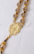 Gloria Aurea gold rosary with smoky quartz beads and Virgin Mary medallion