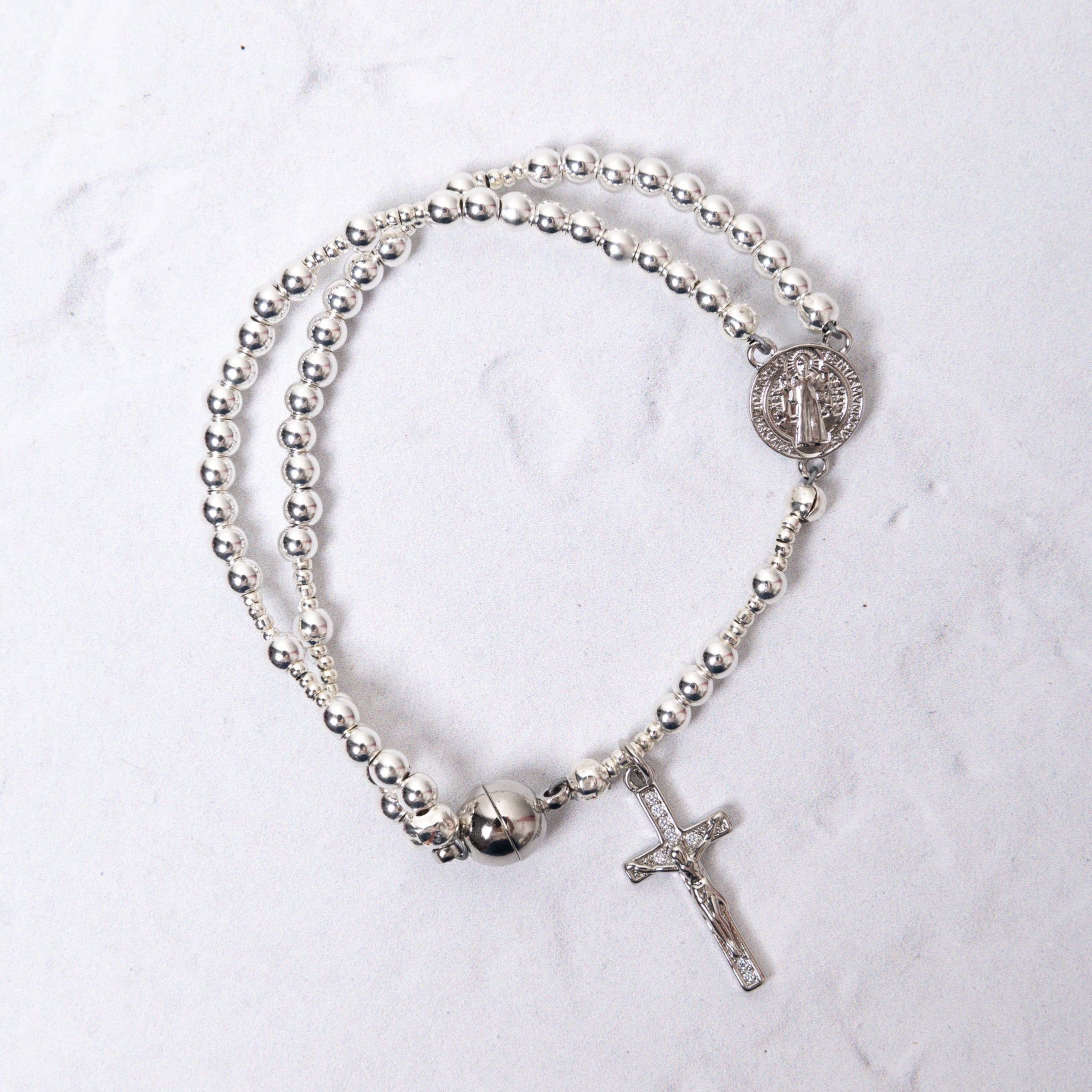 White gold magnetic rosary bracelet with silver medallion and cross
