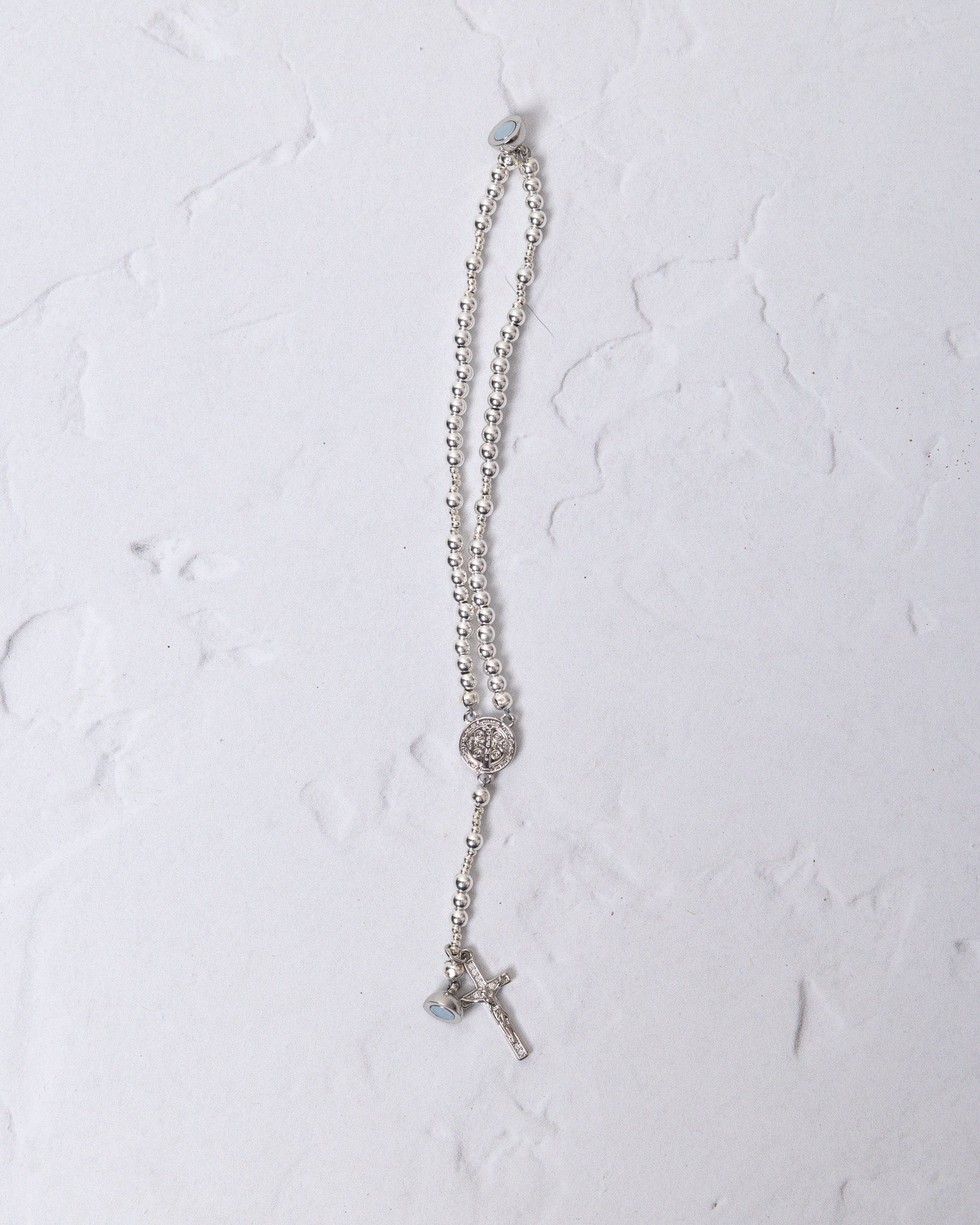 White gold magnetic rosary bracelet with silver beads and crystal centerpiece