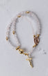 Rose quartz magnetic rosary bracelet with delicate double strands, translucent pink beads, gold-toned accents, and oval medallion
