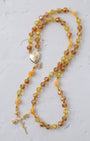 A delicate metamorphosis rosary with faceted amber yellow peach beads and gold heart locket with butterfly charm