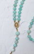 Hydrangea rosary featuring delicate turquoise amazonite beads and a gold toned our lady of guadalupe medallion with crystals