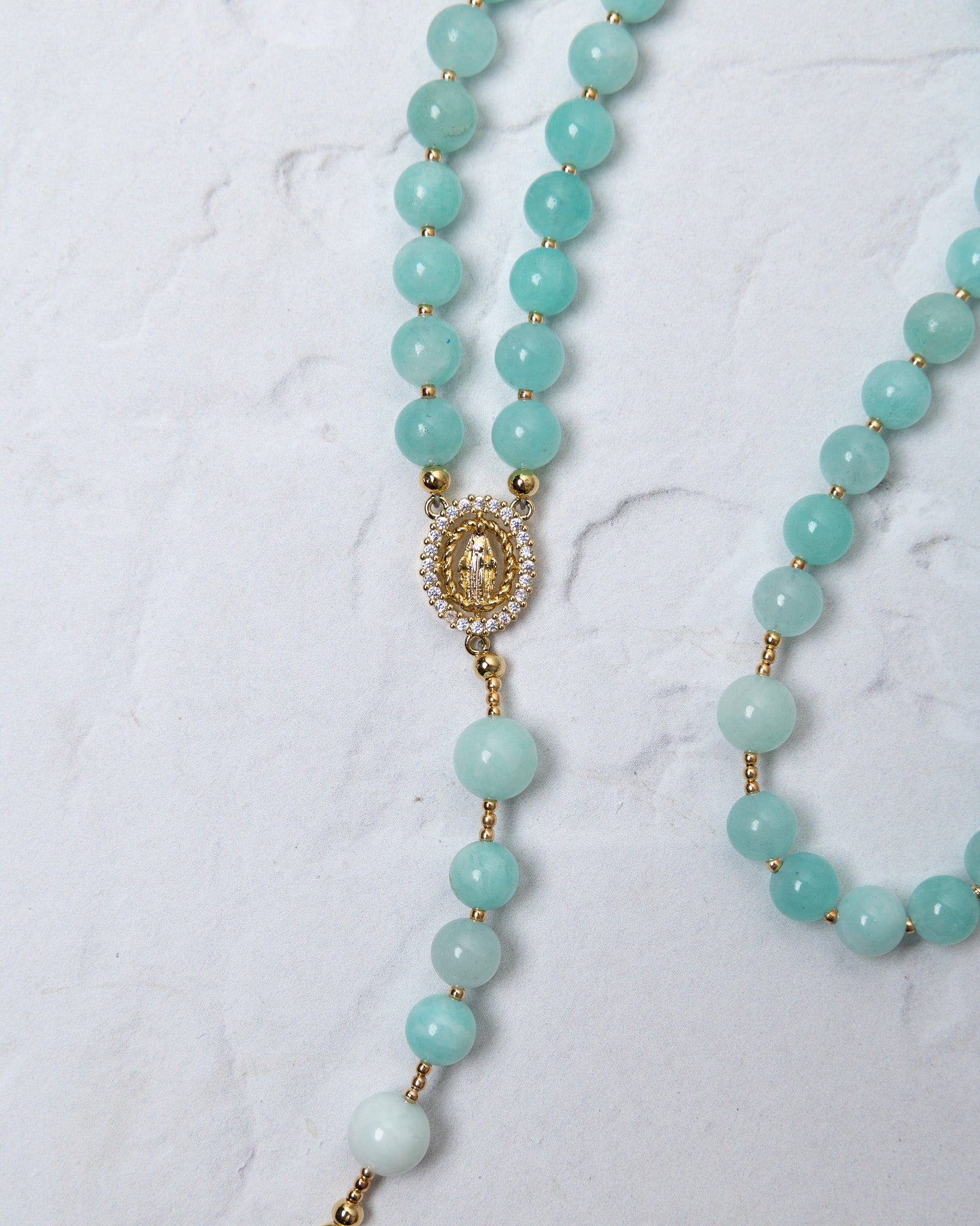 Hydrangea rosary featuring delicate turquoise amazonite beads and a gold toned our lady of guadalupe medallion with crystals