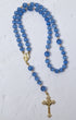 Bluebell rosary featuring delicate blue agate beads with gold-toned metal accents and a detailed cross pendant