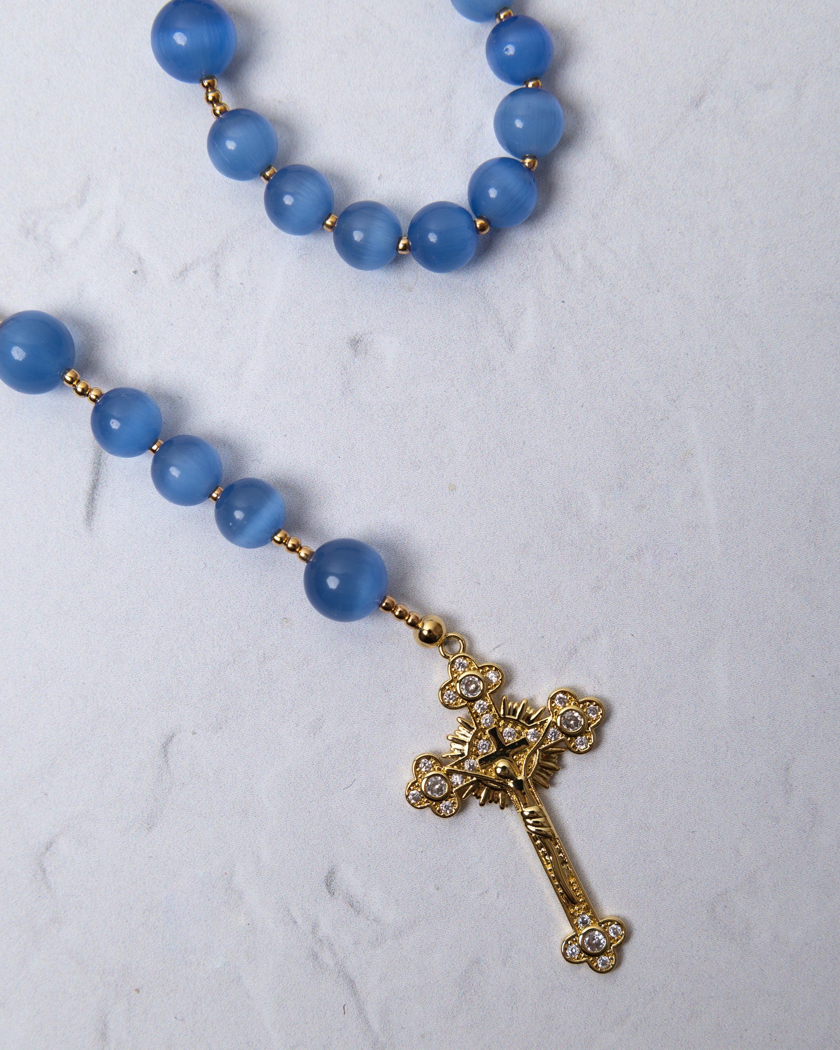 Bluebell rosary with blue matte agate beads gold-toned spacers and gold cross pendant with clear crystals