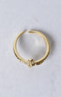 Gold-toned crucifix ring with adjustable band and delicate skull charm adorned with small clear stones
