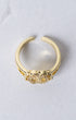 Gold-toned adjustable Marian Halo ring with floral design and clear sparkling stones on band