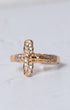 Gold-toned crucifix ring with clear sparkling stones along the cross arms and detailed figure at the center