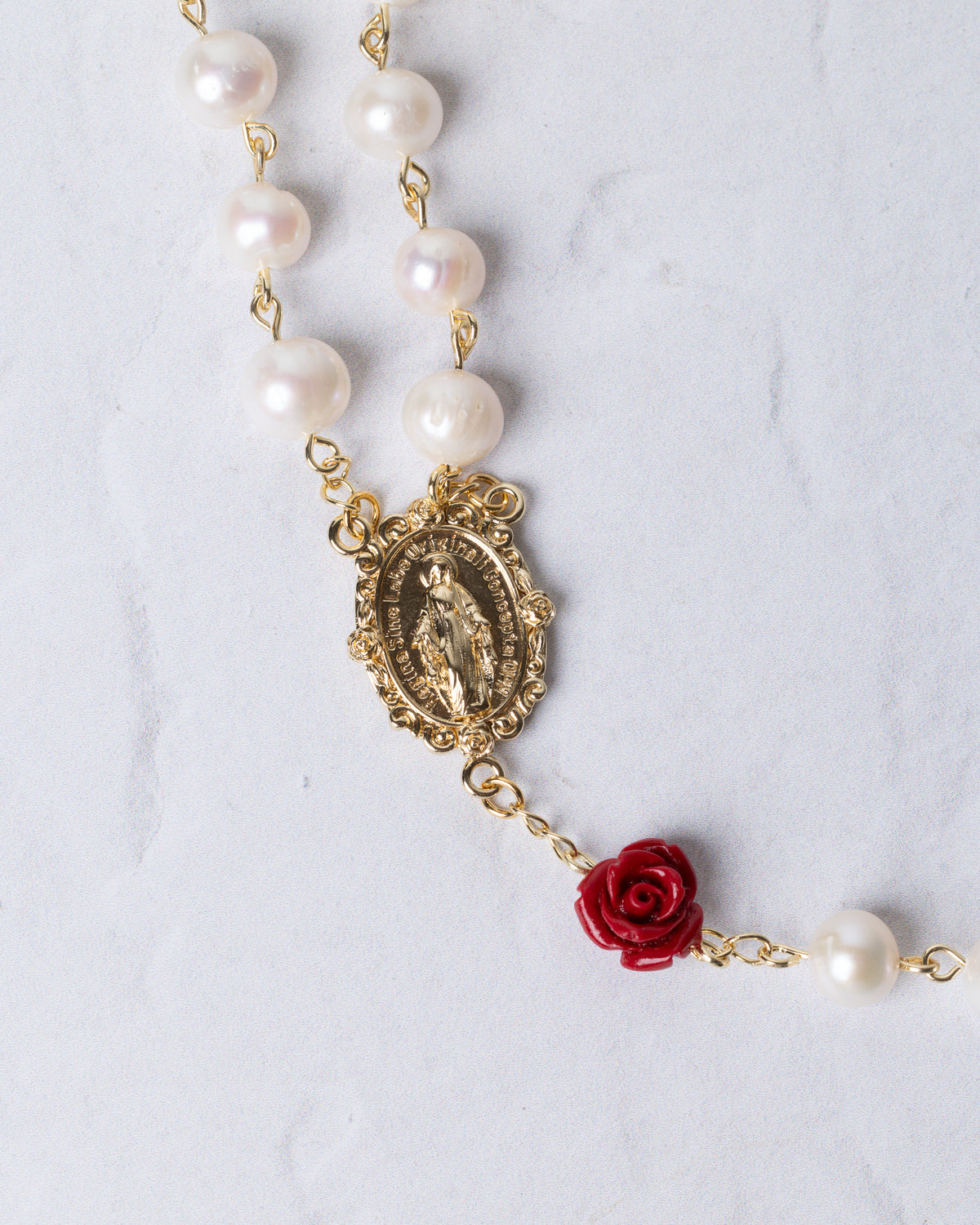 Ivory Rose Pearl Rosary gold-toned with white pearls, ornate religious medallion, and vibrant red rose accent