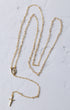The forever rosary necklace gold-toned chain with detailed oval medallion and small cross pendant at the end