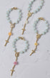 Light blue jade bead rosary bracelet with gold-toned crosses and rose charms for st thereses rose garden car rosary