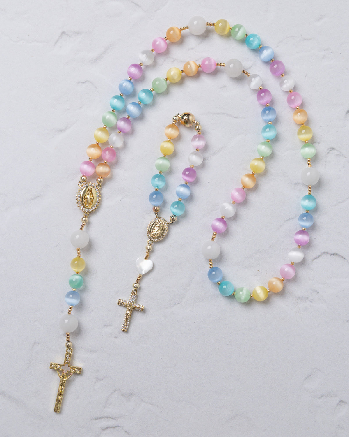Pastel-colored beaded rainbow covenant rosary with gold-toned metal accents and crucifix for prayer use