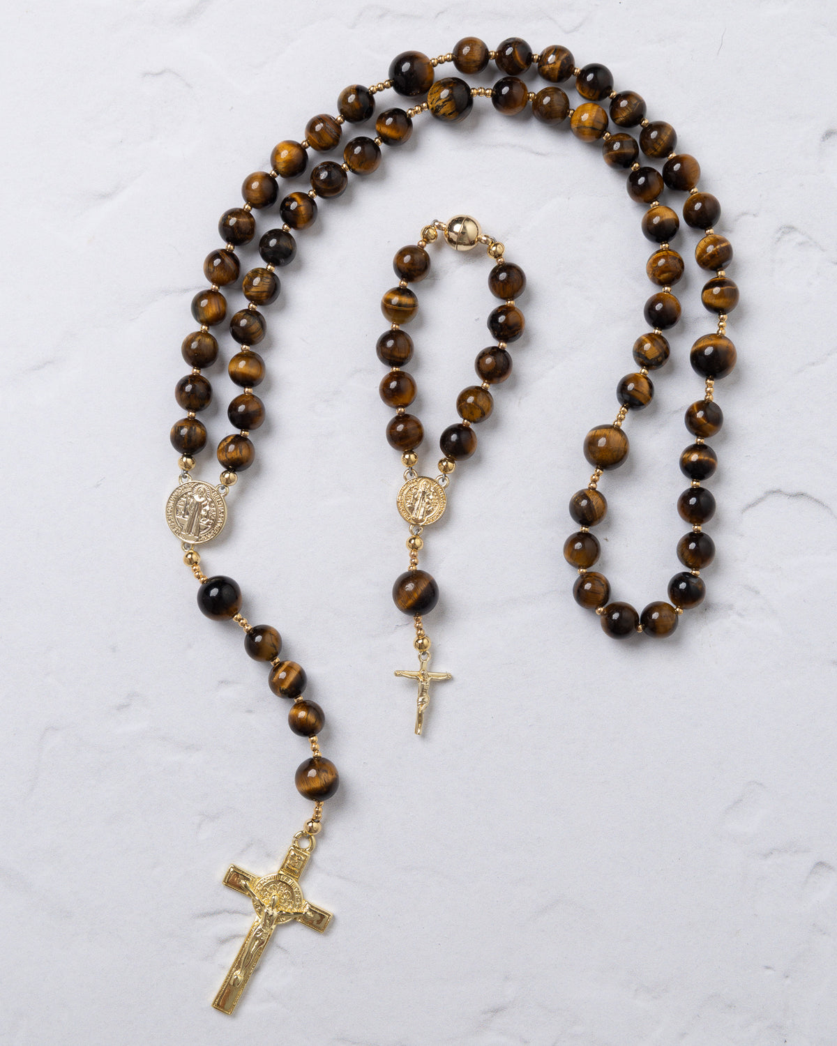 Golden-toned tiger eye bead rosary with detailed crucifix and saint benedict medal fortis benedicta rosary