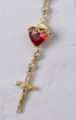 Gold-toned sacred heart steering wheel rosary with a red heart crowned in crystals above a rhinestone crucifix